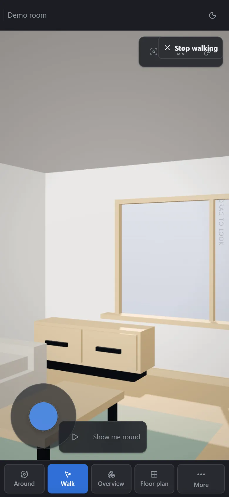 The viewer in a phone-sized browser window in walk mode: the room at eye height, a thumb joystick, and the mode buttons along the bottom.